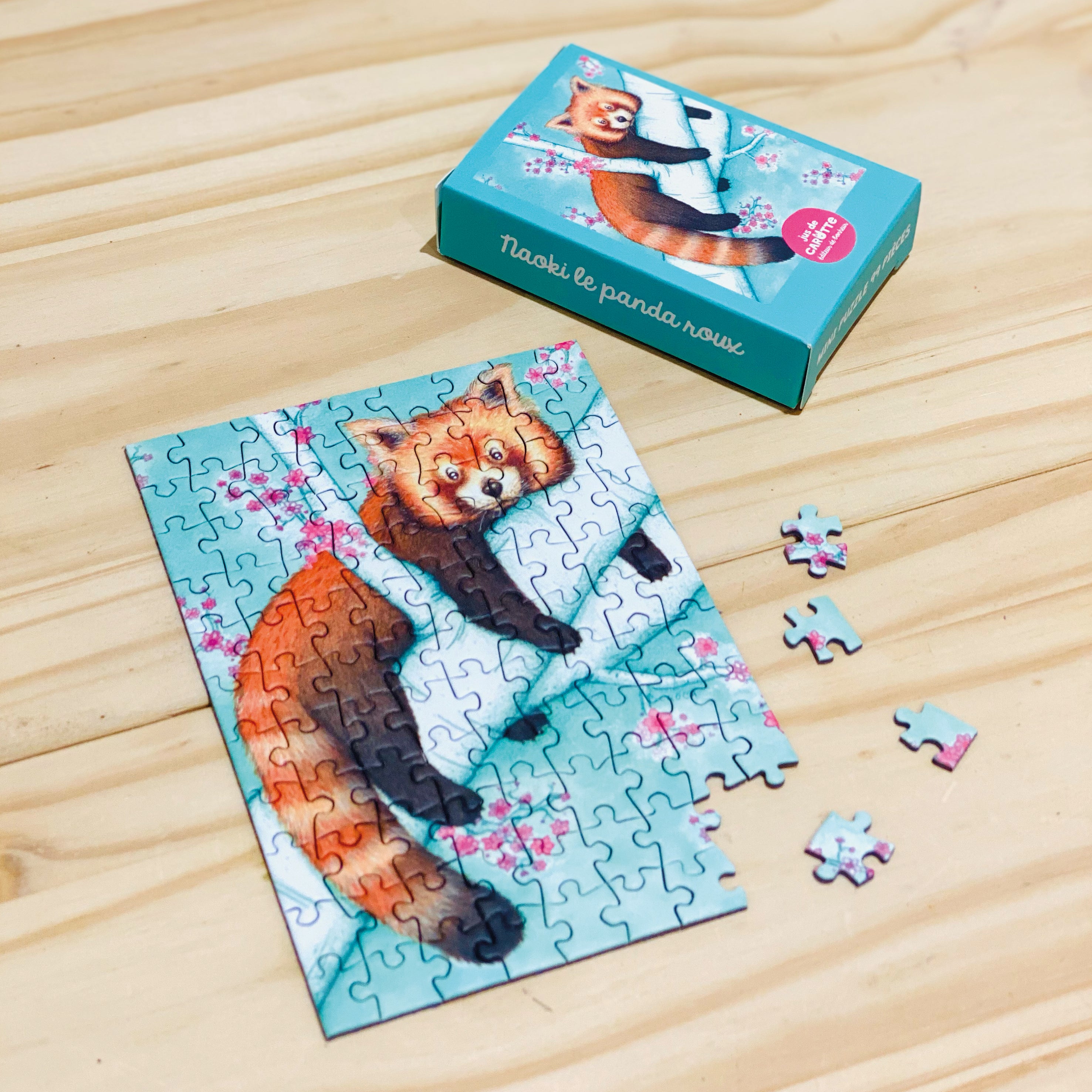 Mini Puzzle 99 pièces Naoki le panda roux